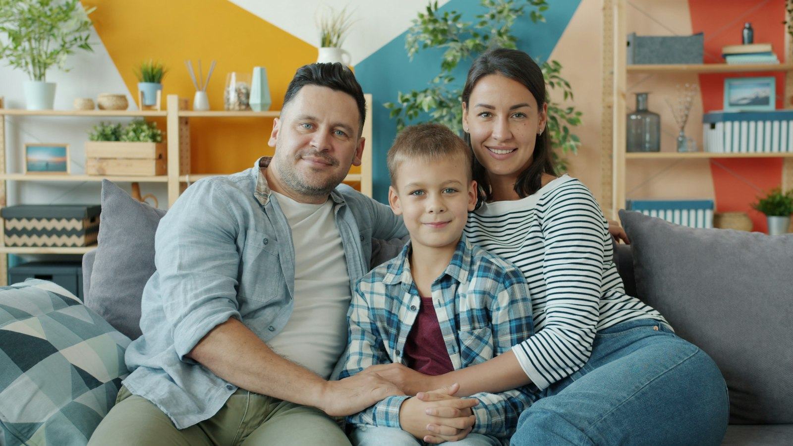 A family relaxing together on the sofa at home