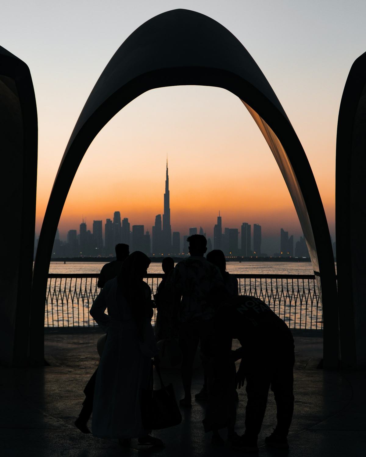 A family watching the sunset over the Dubai skyline